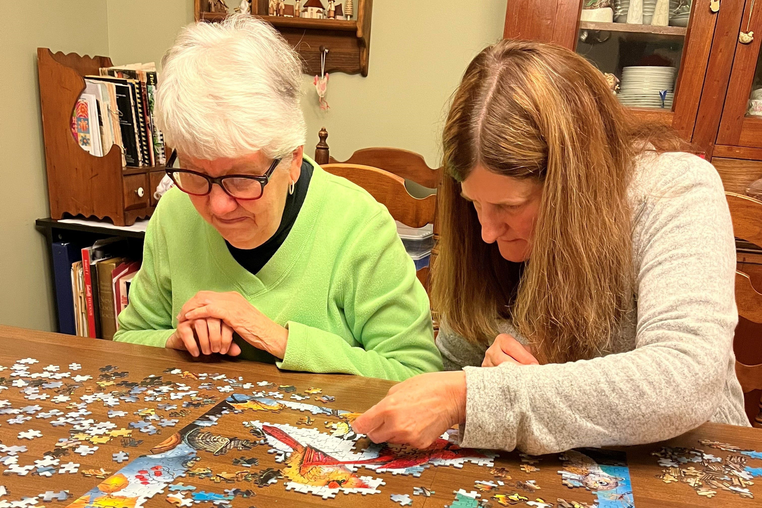 Two women working on a puzzle