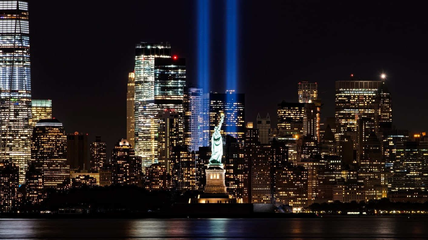 Blue 9/11 memorial lights and the NYC skyline