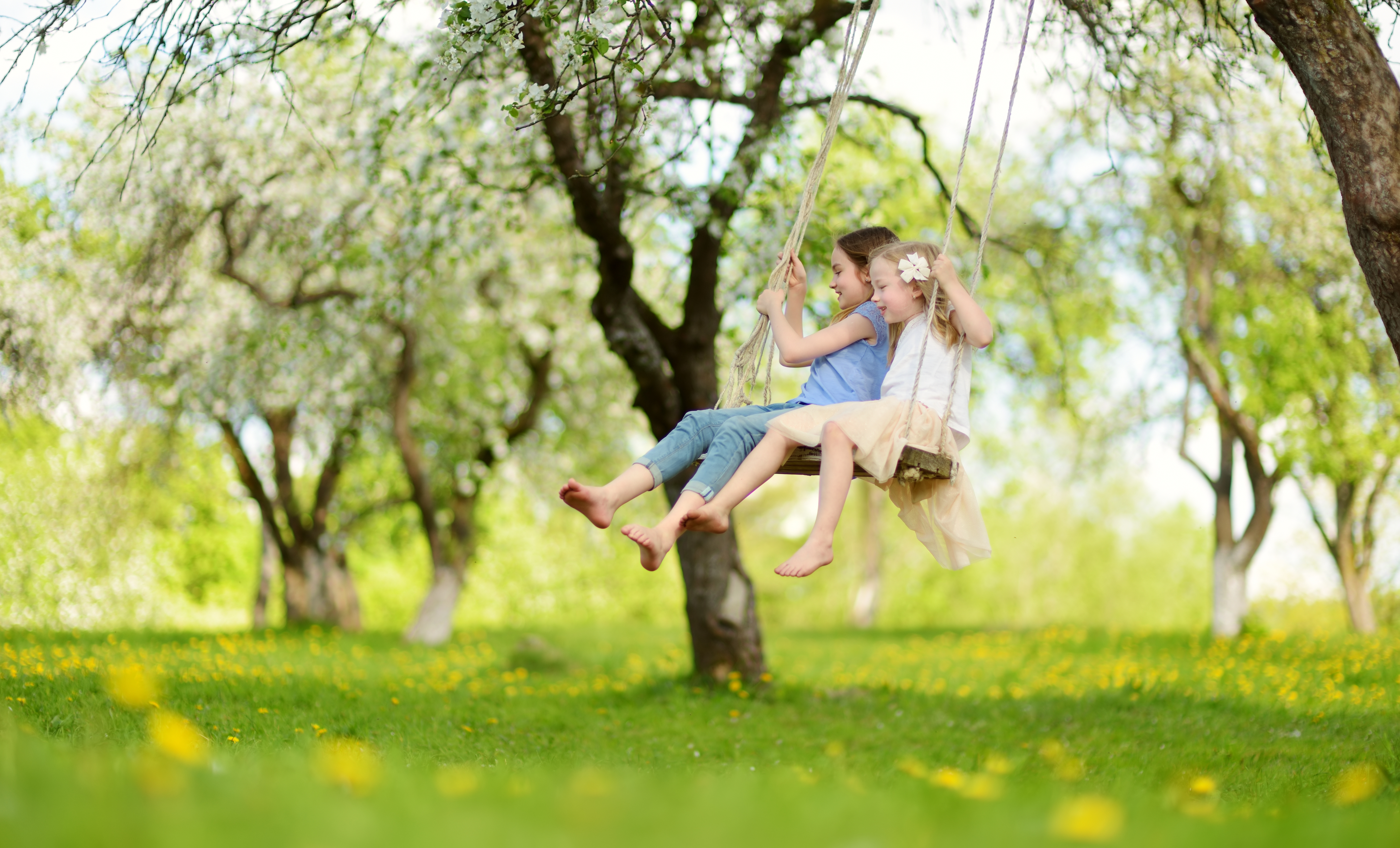 Two Little Girls Swinging Together 