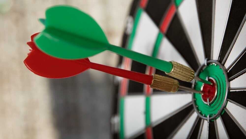 red and green darts in bulls eye