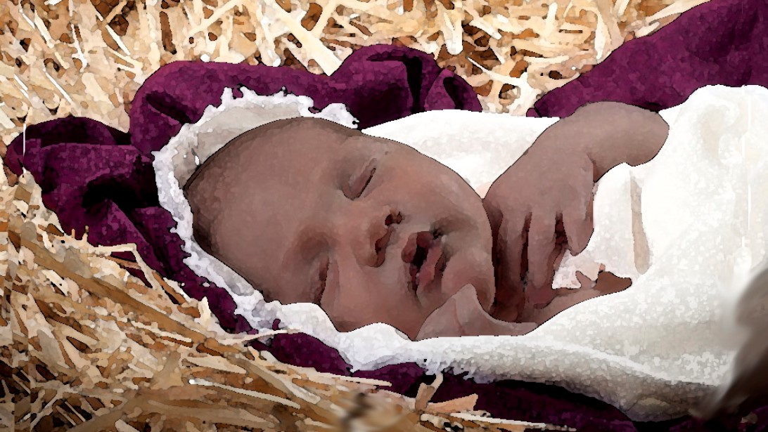 Baby sleeping in a bed of hay